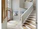 Bright foyer featuring a staircase and entry to the living room at 15702 Muirfield Dr, Odessa, FL 33556