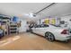 Bright, organized garage with a car, shelving, and tools for storage and easy access at 15702 Muirfield Dr, Odessa, FL 33556
