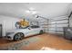 Clean garage with a modern vehicle, white walls and floor at 15702 Muirfield Dr, Odessa, FL 33556
