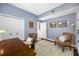 Bright home office with hardwood floors, closet, and comfortable seating area at 15702 Muirfield Dr, Odessa, FL 33556