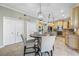 Open-concept kitchen and eat-in area showcasing stainless steel appliances, and a view of the eat-in kitchen at 15702 Muirfield Dr, Odessa, FL 33556