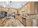 Spacious kitchen featuring stainless steel appliances, granite countertops, and ample cabinet space at 15702 Muirfield Dr, Odessa, FL 33556
