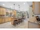 Spacious kitchen featuring an island with bar seating, granite countertops and modern appliances at 15702 Muirfield Dr, Odessa, FL 33556