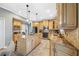 Well-equipped kitchen with custom cabinets, granite counters, stainless appliances, and a center island at 15702 Muirfield Dr, Odessa, FL 33556