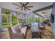 Covered lanai with comfortable seating overlooking the sparkling pool and lush backyard at 15702 Muirfield Dr, Odessa, FL 33556
