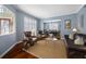 Comfortable living room with hardwood floors, stylish furnishings, and plantation shutters at 15702 Muirfield Dr, Odessa, FL 33556