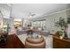 Spacious living room with plush seating, wood floors, and large windows offering abundant natural light at 15702 Muirfield Dr, Odessa, FL 33556