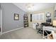 Well-lit home office featuring a desk, shelving, and window with natural light for a productive workspace at 15702 Muirfield Dr, Odessa, FL 33556