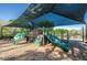 Community playground featuring covered slides and climbing structures for enjoyment at 15702 Muirfield Dr, Odessa, FL 33556