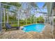 Screened in pool with brick patio and lounge chair at 15702 Muirfield Dr, Odessa, FL 33556