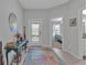 Welcoming foyer featuring a decorative table, a mirror, and an entryway leading to a bedroom at 16542 Delia St, Wimauma, FL 33598