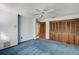 Empty bedroom with blue carpet, light blue walls, a closet, and wood doors at 1672 Winding Creek Rd, Dunedin, FL 34698