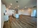 Open-concept kitchen and living area featuring sleek floors and recessed lighting at 17049 James Trl, Parrish, FL 34219