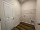 Practical laundry room featuring shelving and ample space for washer and dryer hookups at 17049 James Trl, Parrish, FL 34219