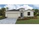 Charming single-story home with stone accents, a two-car garage, and meticulously manicured landscaping at 17053 James Trl, Parrish, FL 34219