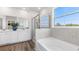 Bathroom featuring dual sinks, soaking tub, and walk-in shower at 17114 James Trl, Parrish, FL 34219