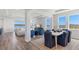 Open-concept dining area with stylish furniture, wood floors, and large windows offering scenic views at 17114 James Trl, Parrish, FL 34219