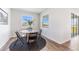 Dining area with hardwood floors, large window, and modern black chairs at 17114 James Trl, Parrish, FL 34219