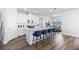 Well-lit kitchen featuring a breakfast bar, white cabinetry, and stylish modern finishes at 17114 James Trl, Parrish, FL 34219