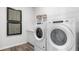 Efficient laundry room with new washer and dryer, storage, and modern decor at 17114 James Trl, Parrish, FL 34219