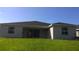 Back exterior view with large windows and grassy yard at 17126 James Trl, Parrish, FL 34219