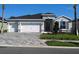 Charming one-story home with three-car garage, stone accents, and manicured landscaping at 17126 James Trl, Parrish, FL 34219