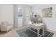 Bright home office with a white desk, stylish chair, and a window with natural light at 17126 James Trl, Parrish, FL 34219