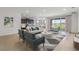 Spacious living area featuring modern decor and seamless flow to the kitchen and dining areas at 17126 James Trl, Parrish, FL 34219