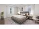 Serene main bedroom with a tray ceiling, plush carpet, and ample natural light from two windows at 17126 James Trl, Parrish, FL 34219