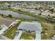 Beautiful property showcasing a meticulous landscape, spacious driveway, and a serene waterfront setting at 1805 Columbine Pl, Sun City Center, FL 33573