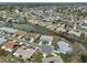 Well-maintained home with waterfront views and attached carport, complemented by a verdant landscape at 1805 Columbine Pl, Sun City Center, FL 33573