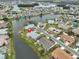 Beautiful waterfront community with lush landscaping and mature trees surrounding a well-maintained home at 1805 Columbine Pl, Sun City Center, FL 33573