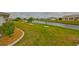 Manicured backyard featuring lush lawn and scenic canal views for outdoor enjoyment at 1805 Columbine Pl, Sun City Center, FL 33573