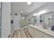 Clean bathroom with double sink vanity, walk-in shower, updated fixtures, and plenty of storage space at 1805 Columbine Pl, Sun City Center, FL 33573