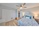 Comfortable bedroom with wood floor, neutral paint, ceiling fan, closet, and access to the rest of the home at 1805 Columbine Pl, Sun City Center, FL 33573
