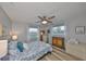 Comfortable bedroom with wood floor, neutral paint, ceiling fan, and large windows for lots of natural light at 1805 Columbine Pl, Sun City Center, FL 33573