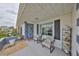 Charming front porch with seating and decorative touches, showcasing the home's inviting exterior and curb appeal at 1805 Columbine Pl, Sun City Center, FL 33573