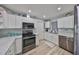 Well-lit kitchen with stainless steel appliances, white cabinetry, and modern countertops at 1805 Columbine Pl, Sun City Center, FL 33573