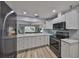 Modern kitchen showcasing stainless steel appliances and white cabinets at 1805 Columbine Pl, Sun City Center, FL 33573