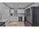 Bright kitchen features stainless steel appliances, white cabinets, and marble countertops at 1805 Columbine Pl, Sun City Center, FL 33573