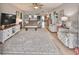 Inviting living room features wood flooring, area rug, ceiling fan, and comfortable seating, ideal for relaxing and entertaining at 1805 Columbine Pl, Sun City Center, FL 33573