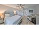 Serene main bedroom features a cozy chair, wood flooring, neutral paint, and is connected to the main bath and walk-in closet at 1805 Columbine Pl, Sun City Center, FL 33573