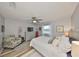 Relaxing main bedroom with neutral walls, wood floor, ceiling fan, and large window creates a serene atmosphere at 1805 Columbine Pl, Sun City Center, FL 33573