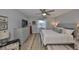 Bright main bedroom showcases wood floors, neutral walls, ample natural light, and a ceiling fan for a refreshing ambiance at 1805 Columbine Pl, Sun City Center, FL 33573