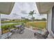 Relax and unwind on this covered patio with serene waterfront vistas at 1805 Columbine Pl, Sun City Center, FL 33573