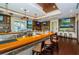 Upscale bar with dark wood floors, tan colored walls and a yellow colored bar with televisions mounted on the walls at 18186 Sandy Pointe Dr, Tampa, FL 33647