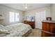 Bedroom features a floral-print bedspread and matching wooden furniture at 18186 Sandy Pointe Dr, Tampa, FL 33647