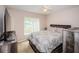 A warm bedroom features neutral tones and a window view at 18186 Sandy Pointe Dr, Tampa, FL 33647