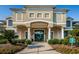 Exterior of a clubhouse showing the well maintained landscaping, walkway, and columns at 18186 Sandy Pointe Dr, Tampa, FL 33647