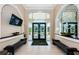 Clubhouse lobby with large windows, tile flooring, benches and TV at 18186 Sandy Pointe Dr, Tampa, FL 33647